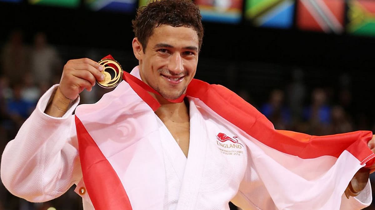 Science to Slam. Image of Ashley McKenzie holding a medal.